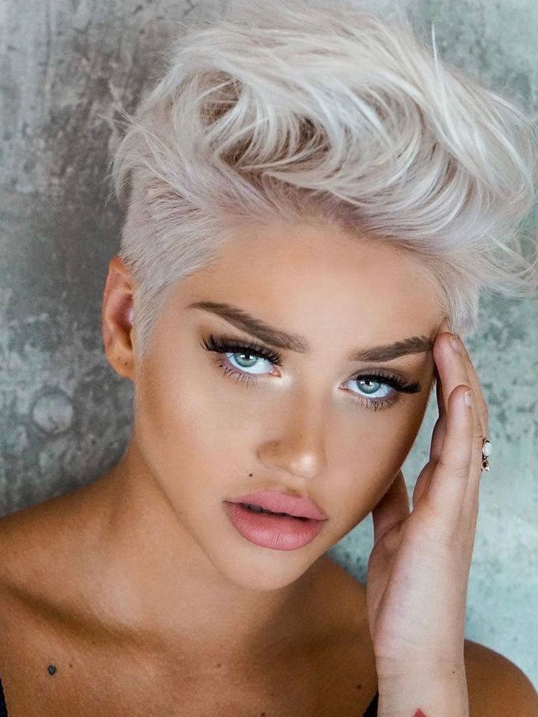 Woman with a silver blonde pixie quiff with an undercut