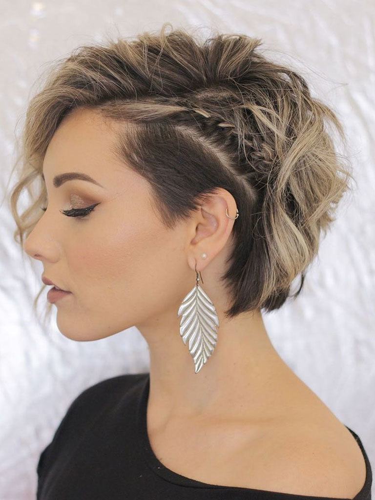 side view of woman with short brown hair with blonde highlights styled with a undercut and braid
