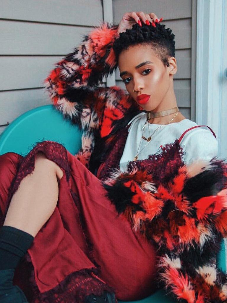 Woman with short natural twisted hair with a side shave