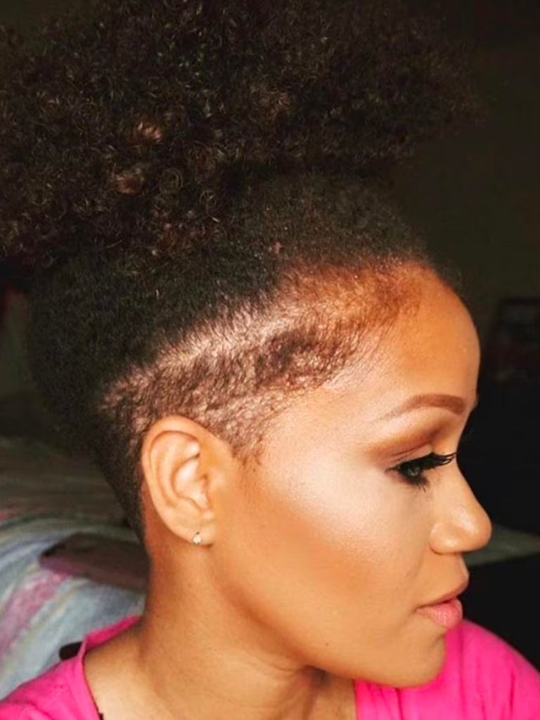 Woman with natural hair in a bun with an undercut