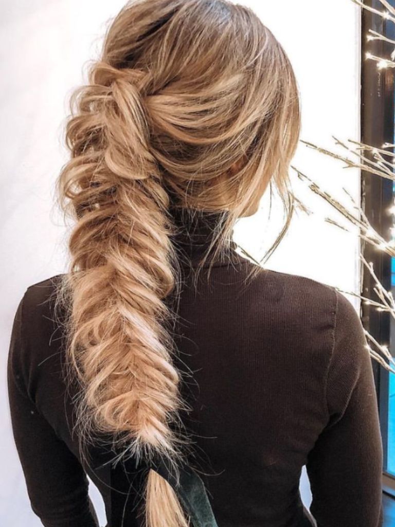 Woman wearing braided fishtail ponytail