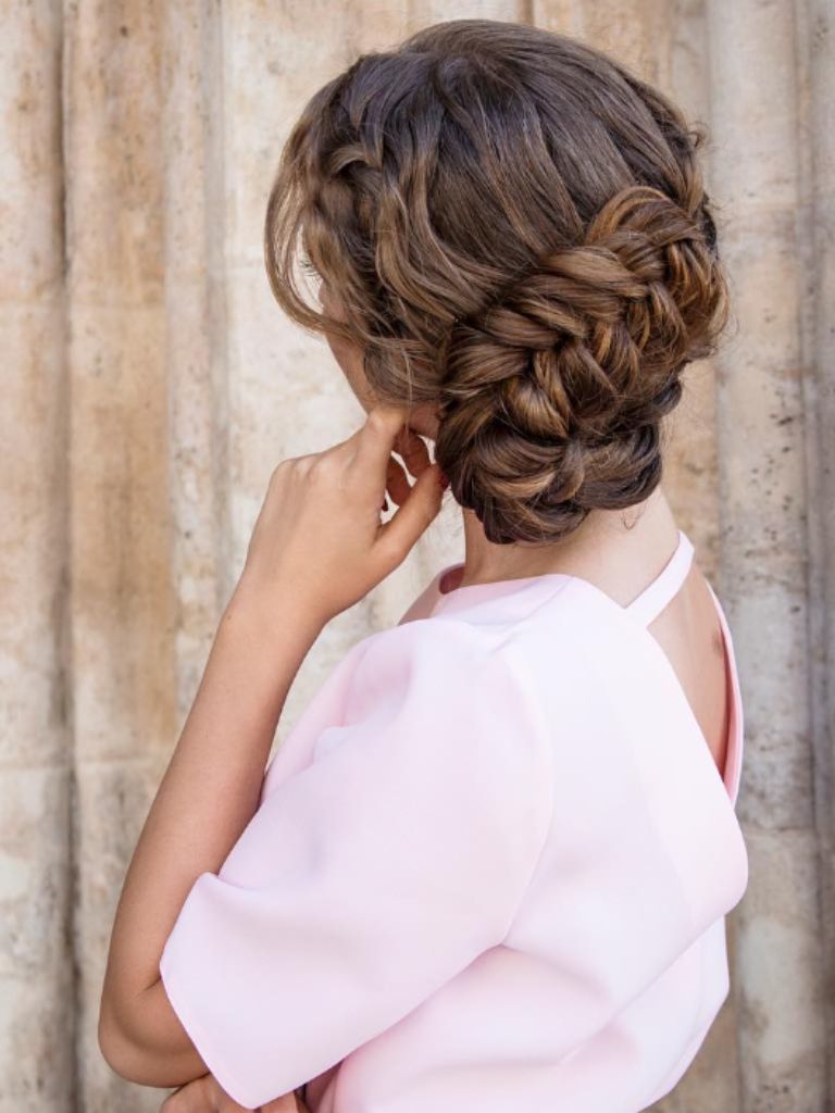 Woman with fishtail side bun.