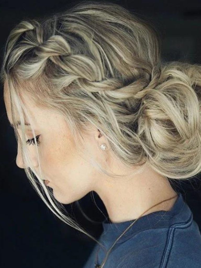 Updos with braids: Close up shot of a woman with rope twisted braid into a low bun.