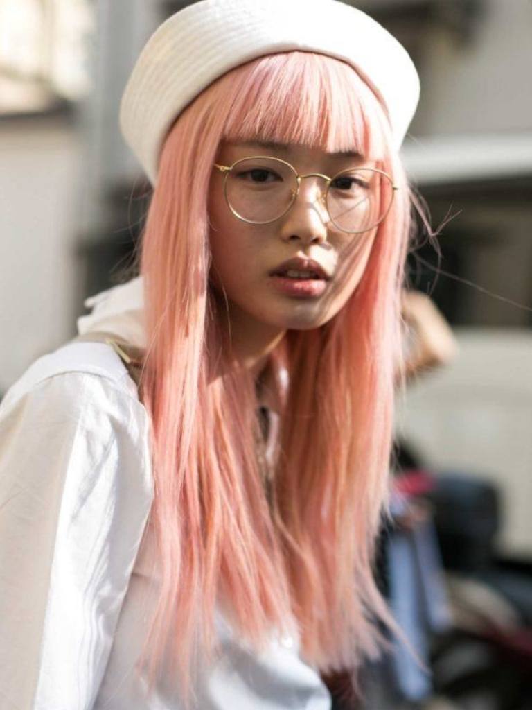 Woman with pink hair and white hat
