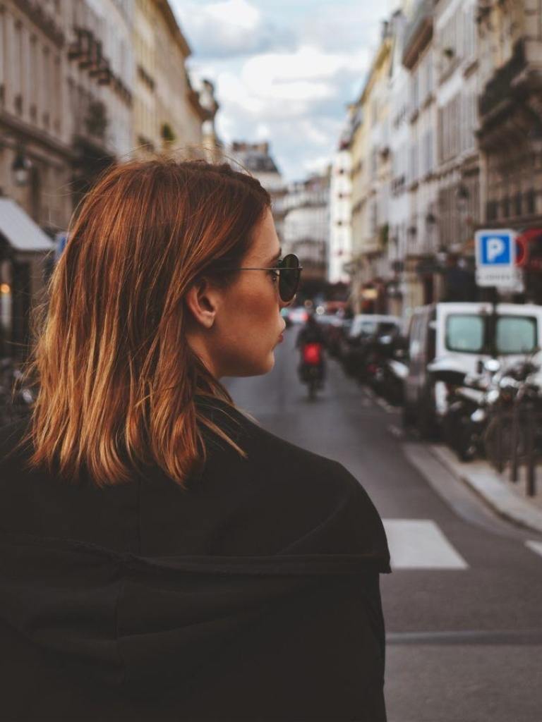 Woman with brown balayage with her back turned.