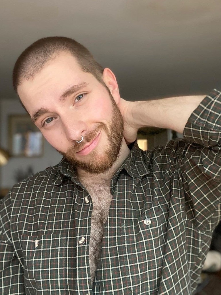 Man with a shaved buzz cut with facial hair