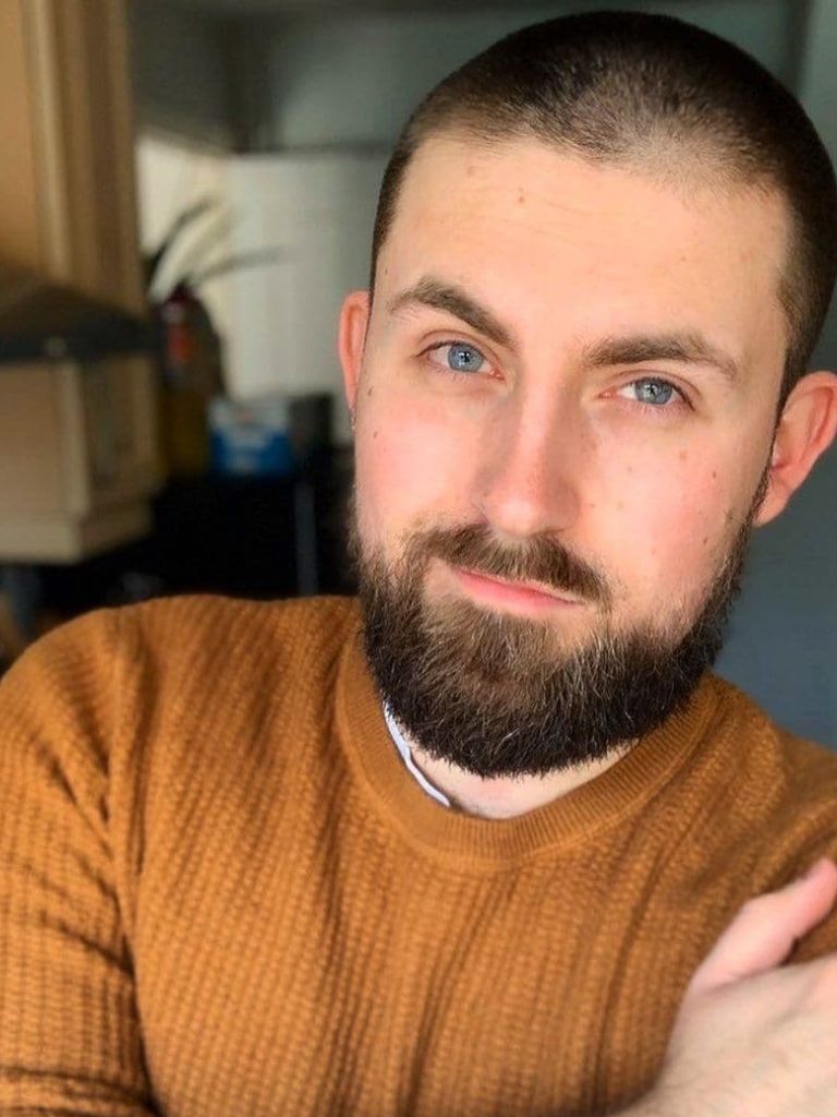Man with short shaved hair with a beard