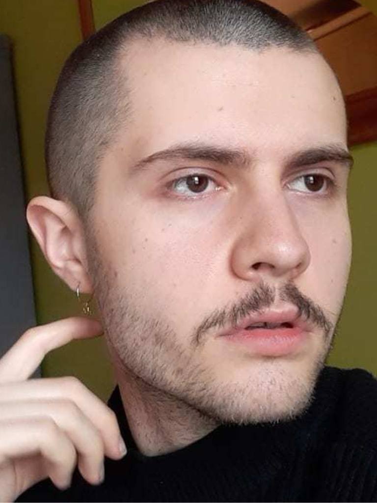 Man with a buzz cut and moustache