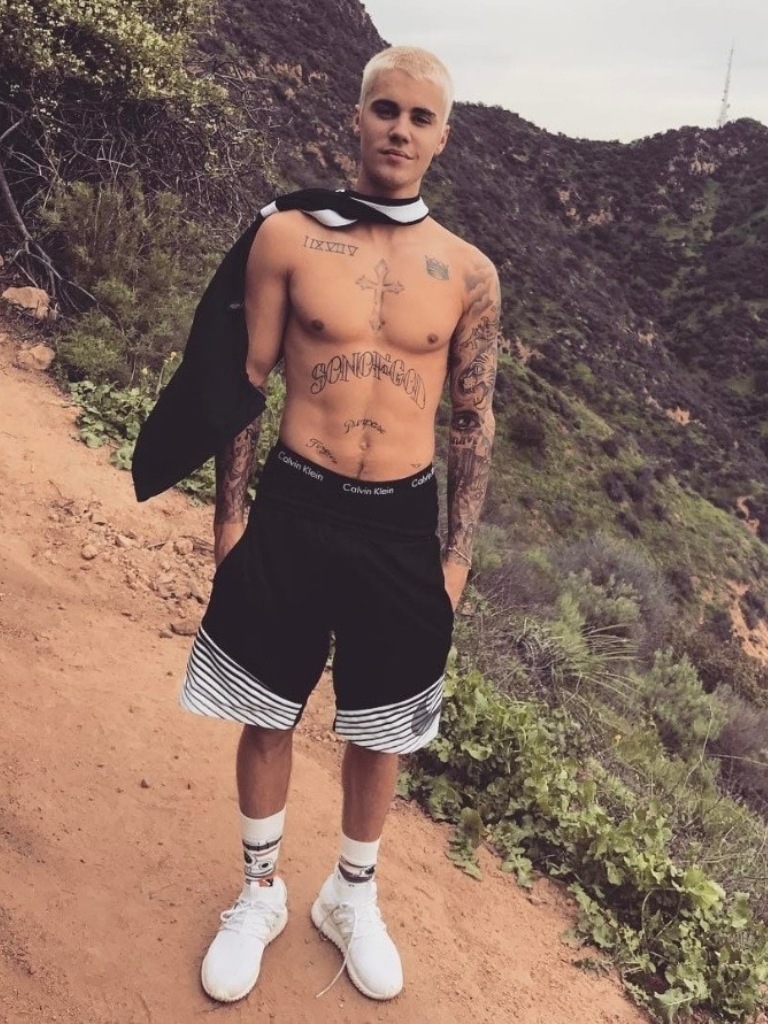 topless justin bieber on a hill with platinum blonde buzz cut hair