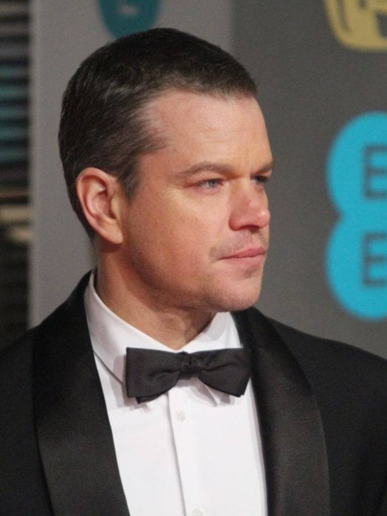 Matt Damon wearing black tie with a buzz cut