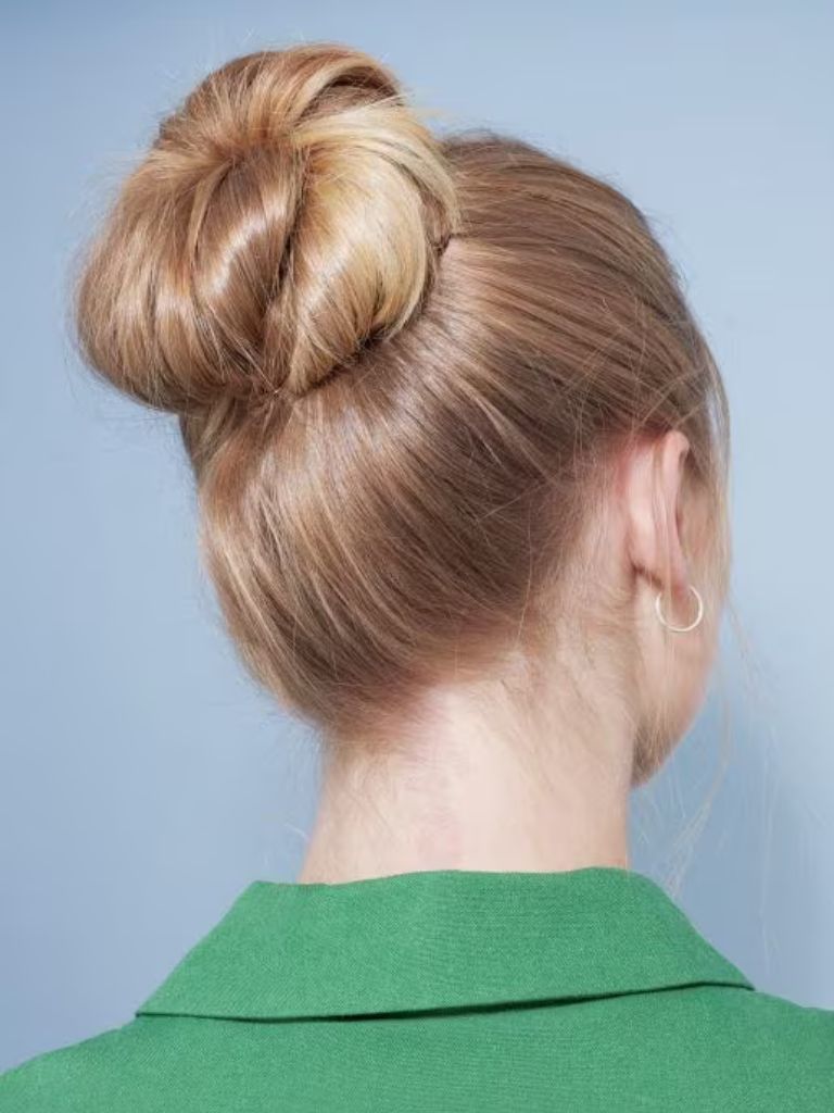 Woman with golden hair styled into a bun