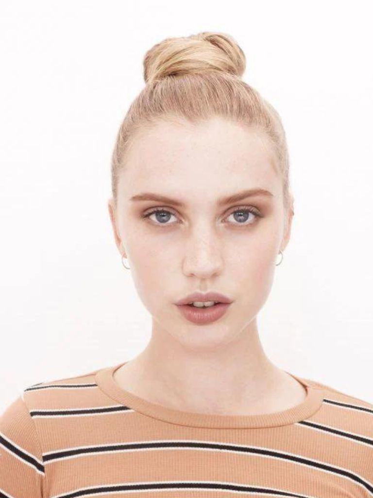 Blonde woman with a tight ballerina bun