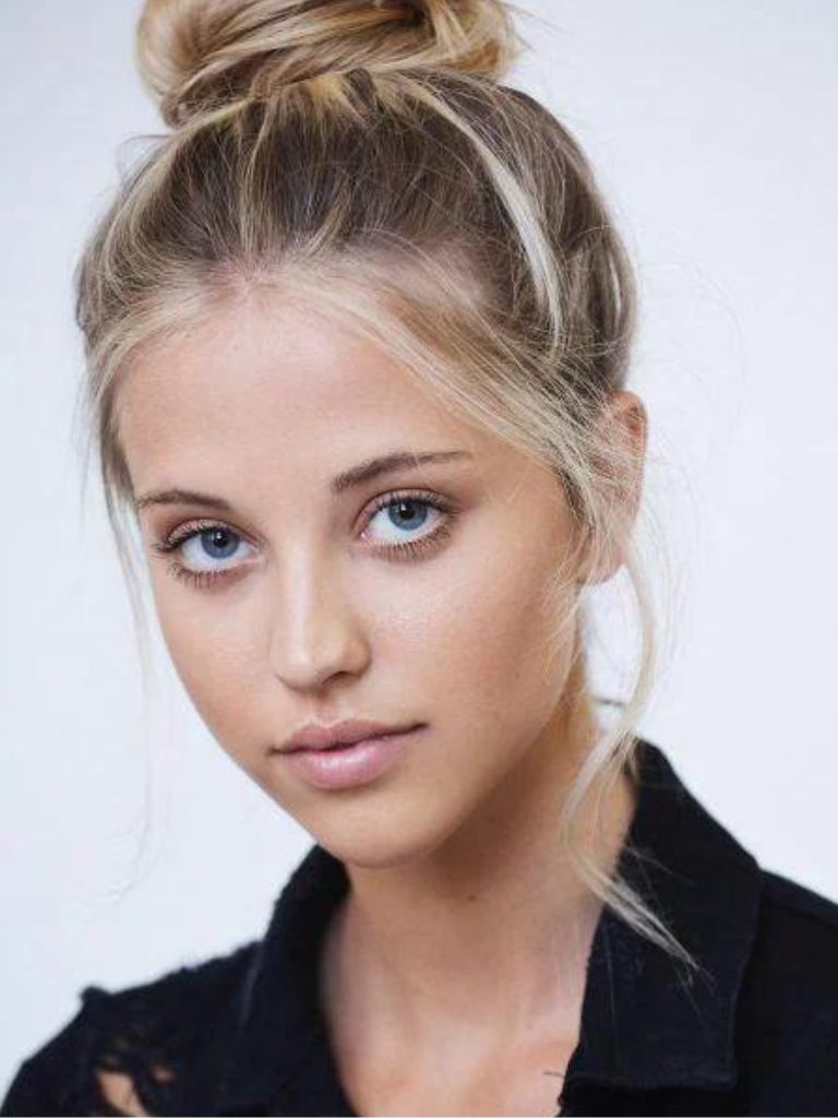 Woman with messy blonde bun hairstyle