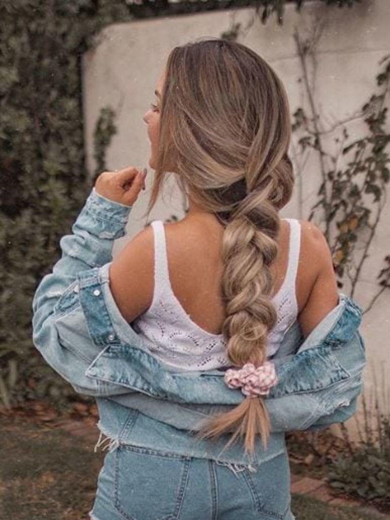 Woman with ash brown hair in single braid