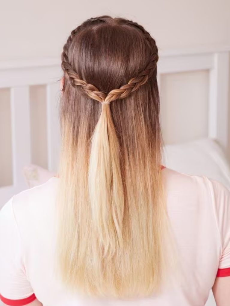 Woman with brunette and blonde ombre hair in a half-up half-down braid