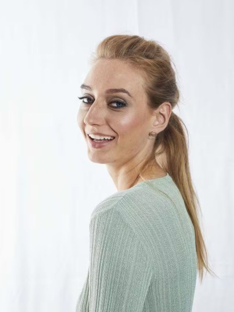 Woman with bump quiff ponytail wearing green