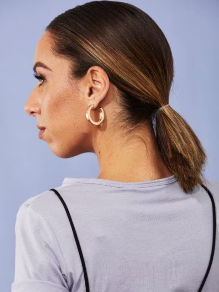 Woman with brown ombre hair in slick ponytail
