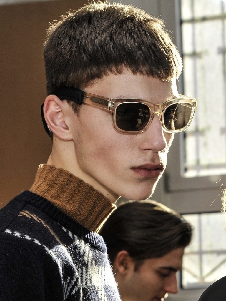 Crop haircut: Brunette male model backstage wearing sunglasses with a french crop haircut