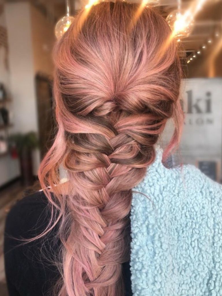 Woman with long hair styled into a fishtail braid