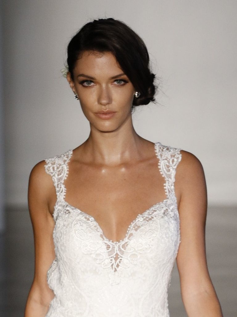 Woman on catwalk with side chignon and wedding dress