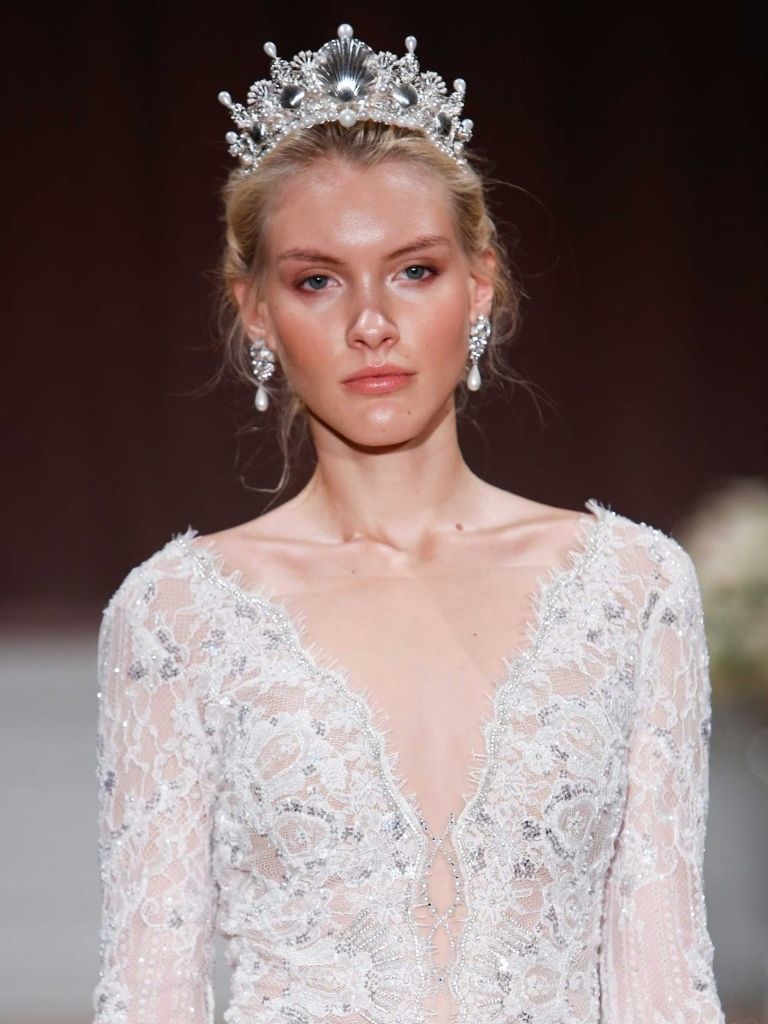 Model on catwalk with wedding dress and tiara