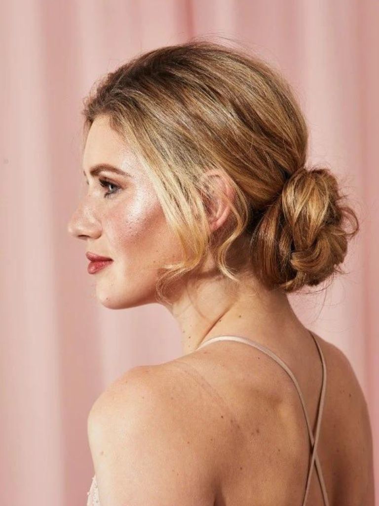 Blonde messy braided low chignon bun hairstyle