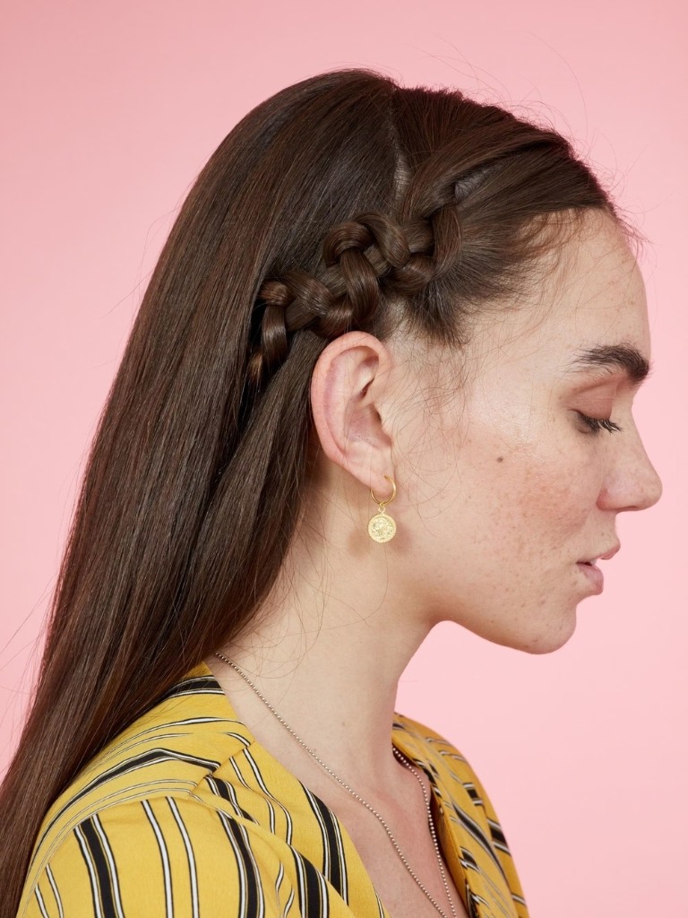 Woman with dark hair wearing a snake braid