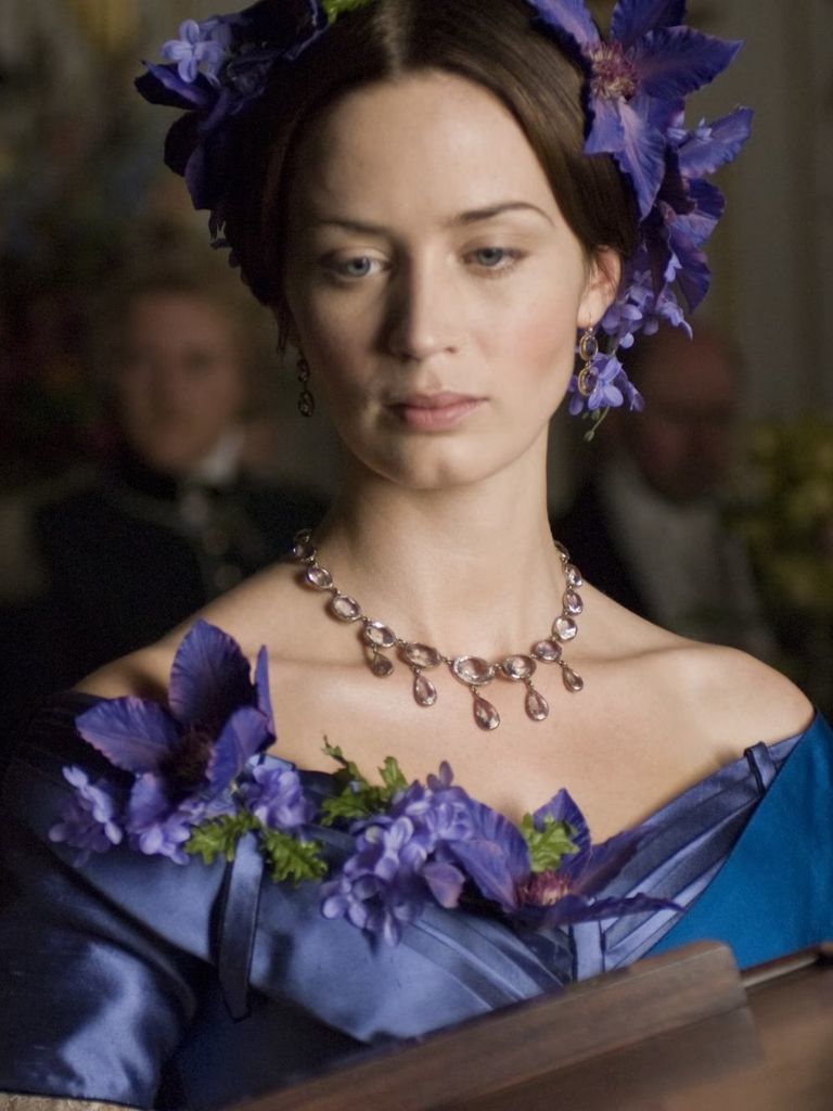 Victorian hairstyles: Photo of Emily Blunt in The Young Victoria with a middle parting and purple floral hair accessories