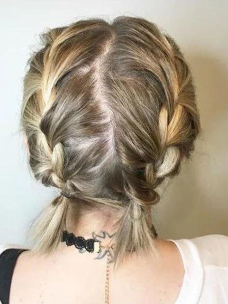 Easy braids for short hair: Back view of short blonde hair in two French braided pigtails.