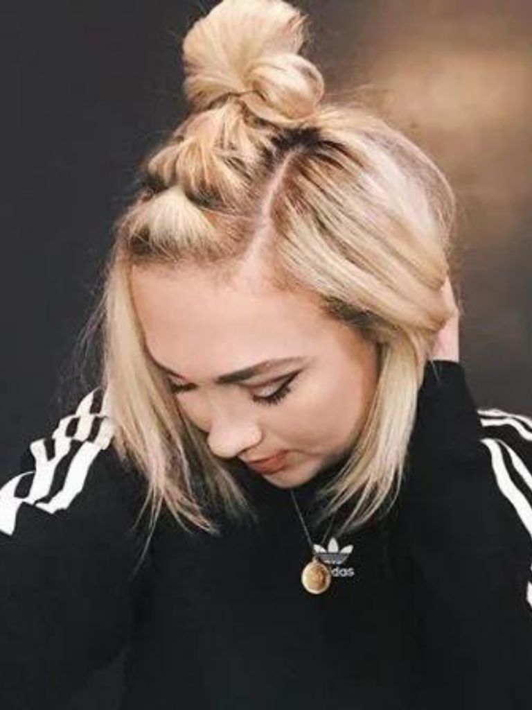 Easy braids for short hair: Blonde woman with short lob hair in a half up pull-through braided bun.
