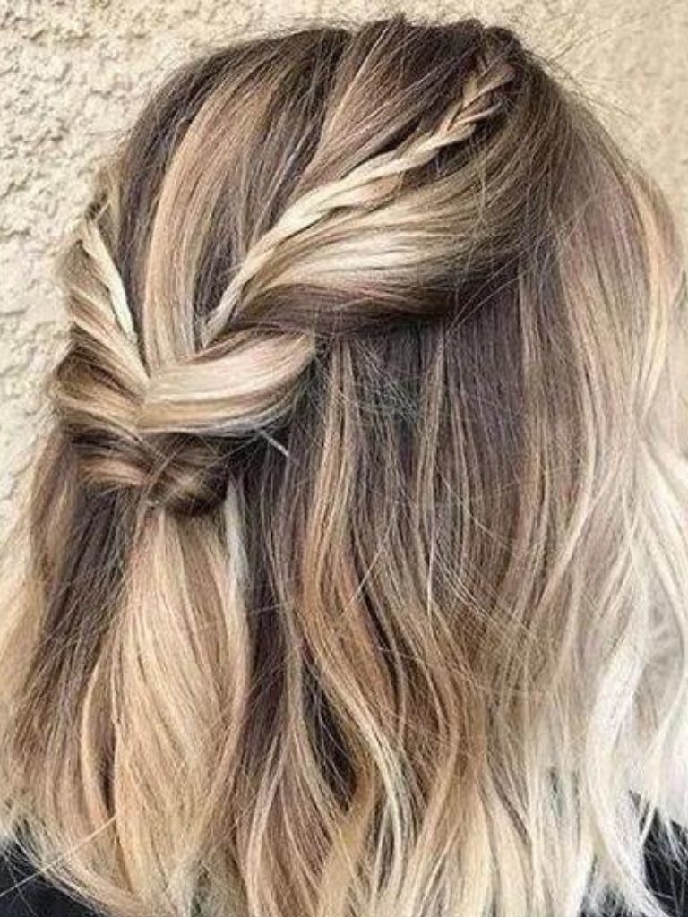 Easy braids for short hair: Back view of a woman with ash blonde hair in a half up twisted with small braided details