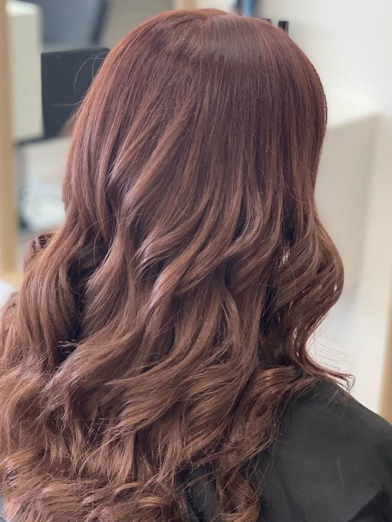 Woman with curly mahogany brown hair