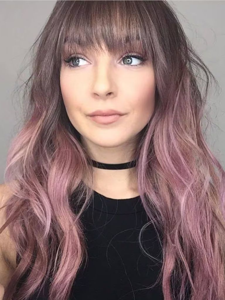 Woman with pink ombre hair and straight wispy bangs
