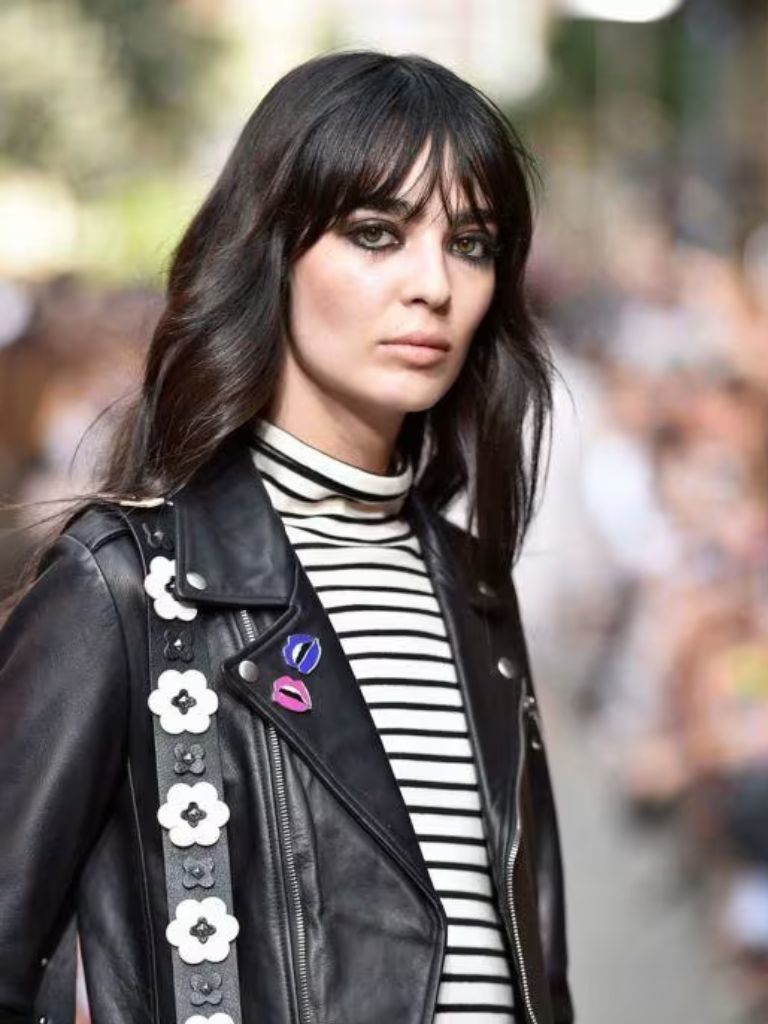 Woman with wavy long bob with grunge wispy bangs cut
