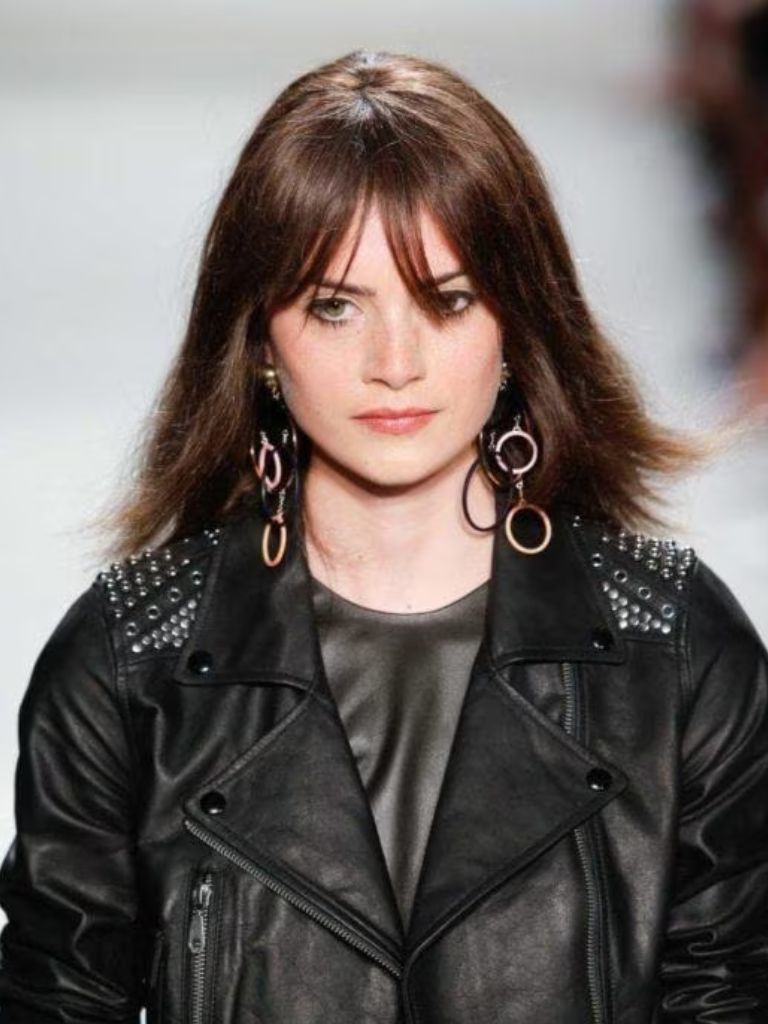 Woman with straight hair and subtle wispy fringe haircut