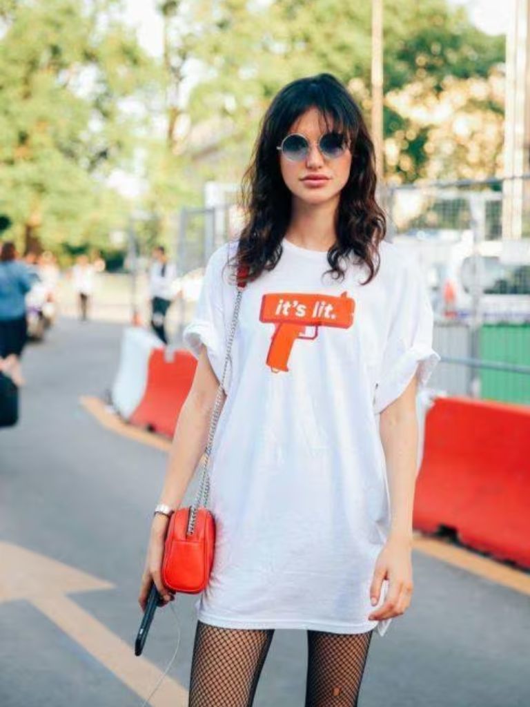 Woman with curly shag haircut with wispy bangs