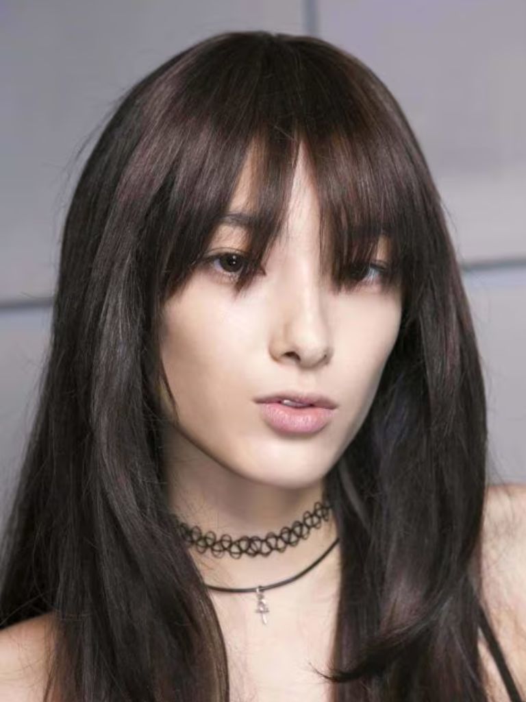 Woman with thick curtain style bangs