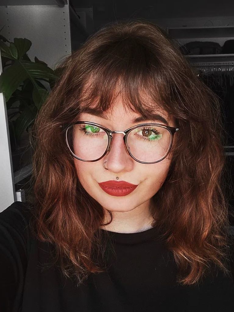 Woman with medium length hair and wispy fringe
