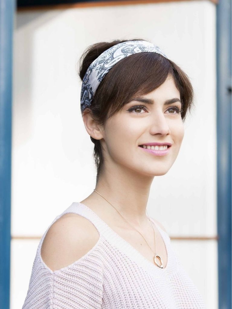 a girl with faux bangs hair smiling outside