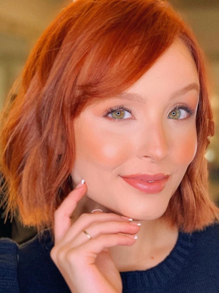 Woman with short ginger hair and side fringe