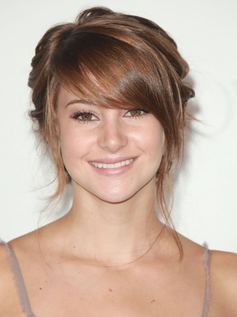 actress shailene woodley with soft brunette swoop bangs in an updo
