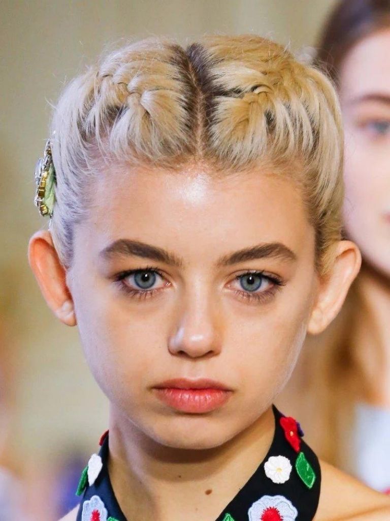 Model with blonde short hair in braids