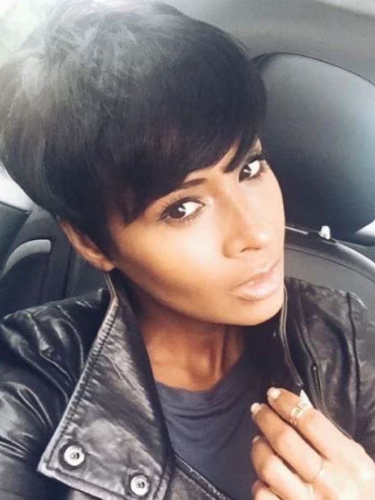 Woman with straight dark brown long pixie cut