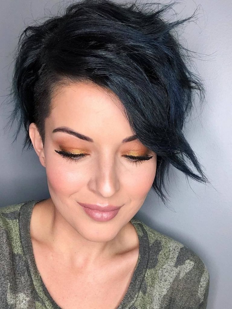 woman with dark brown side swept long bangs and pixie cut