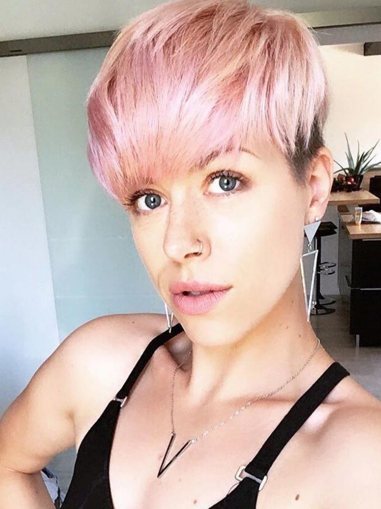 woman with a long face with a pink pixie cut hairstyle