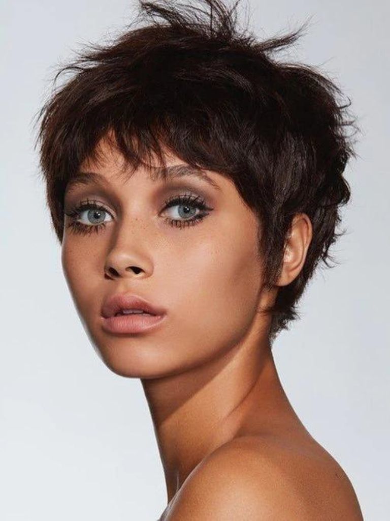 woman with dark brown messy 60s pixie haircut