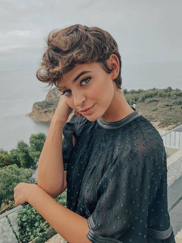 woman with thick medium brown pixie cut