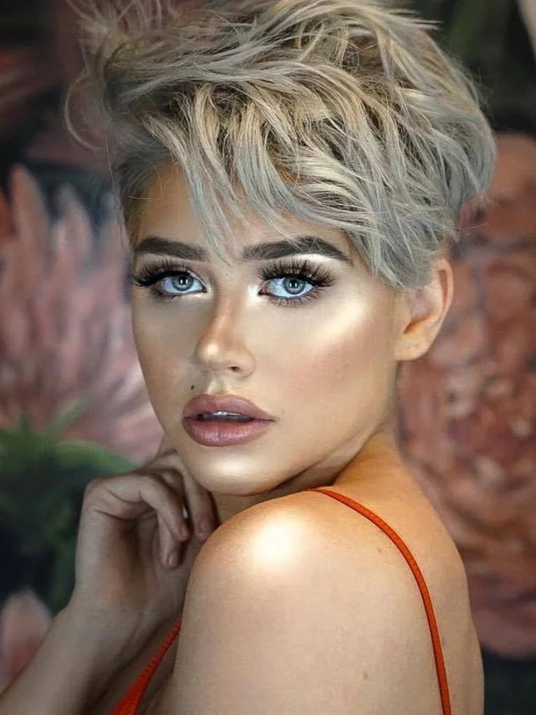 woman with silver blonde wavy pixie haircut