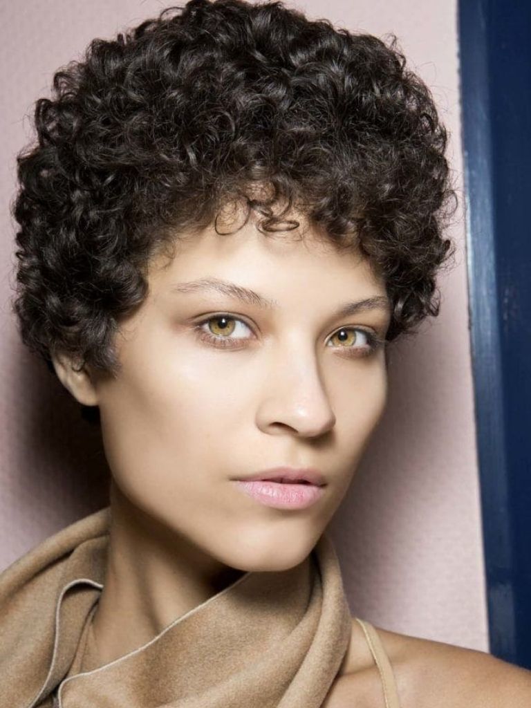 Woman with short curly brown hair