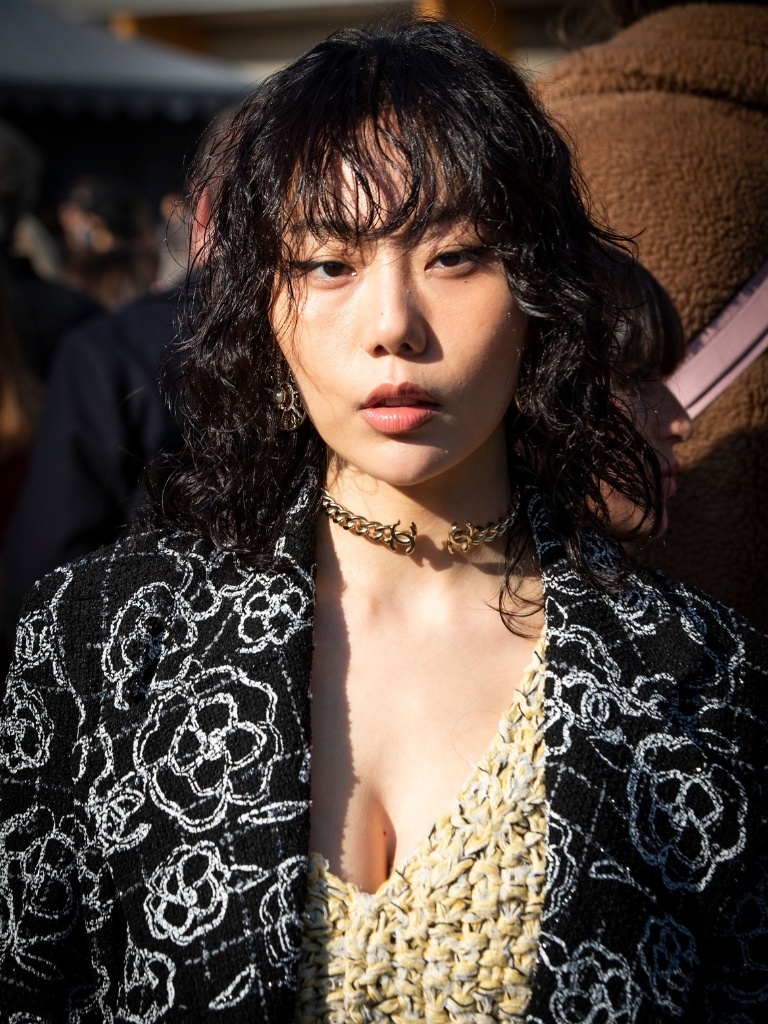 Woman with a curly lob with a fringe